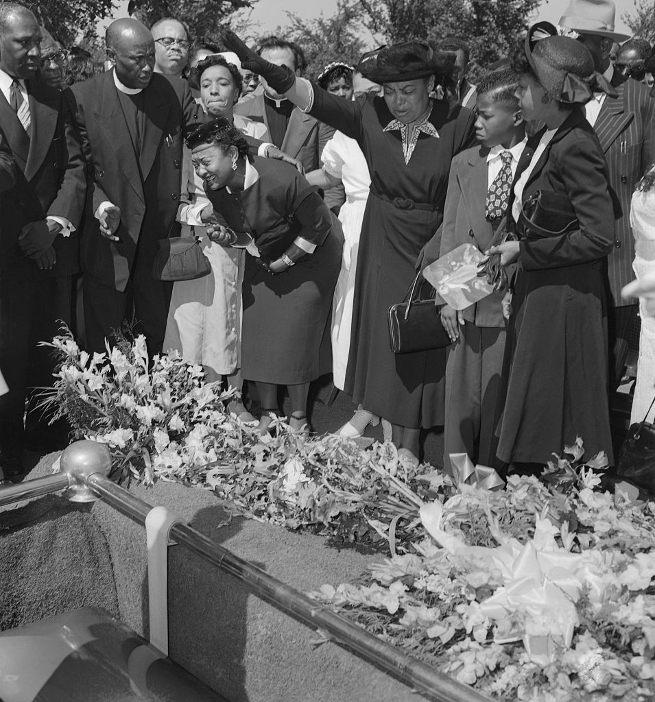 Mrs. Mamie Bradley Watches as Her Son is Lowered into the Ground